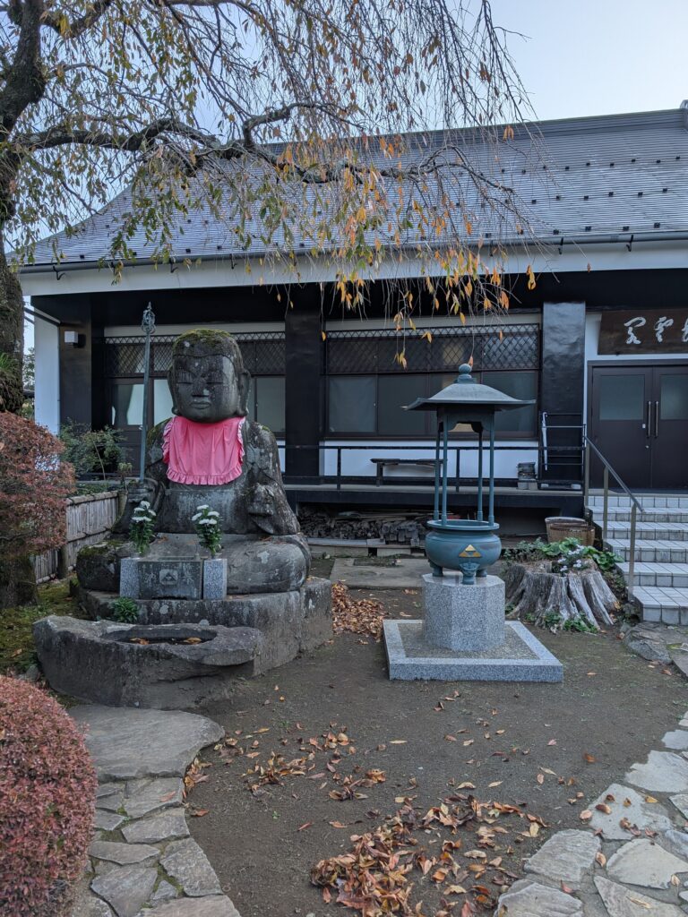 stateus outside of a temple with the Zelda triforce symbol on them