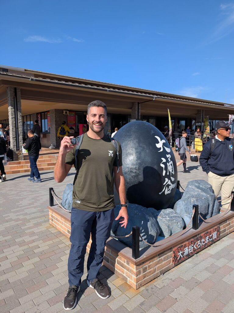 Me standing in front of a giant black egg with a black egg in hand