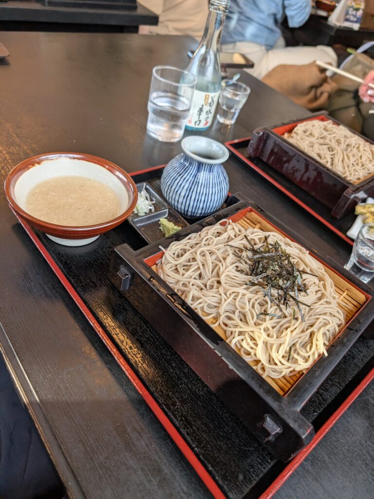 a plate of cold soba noodles and dipping sauce