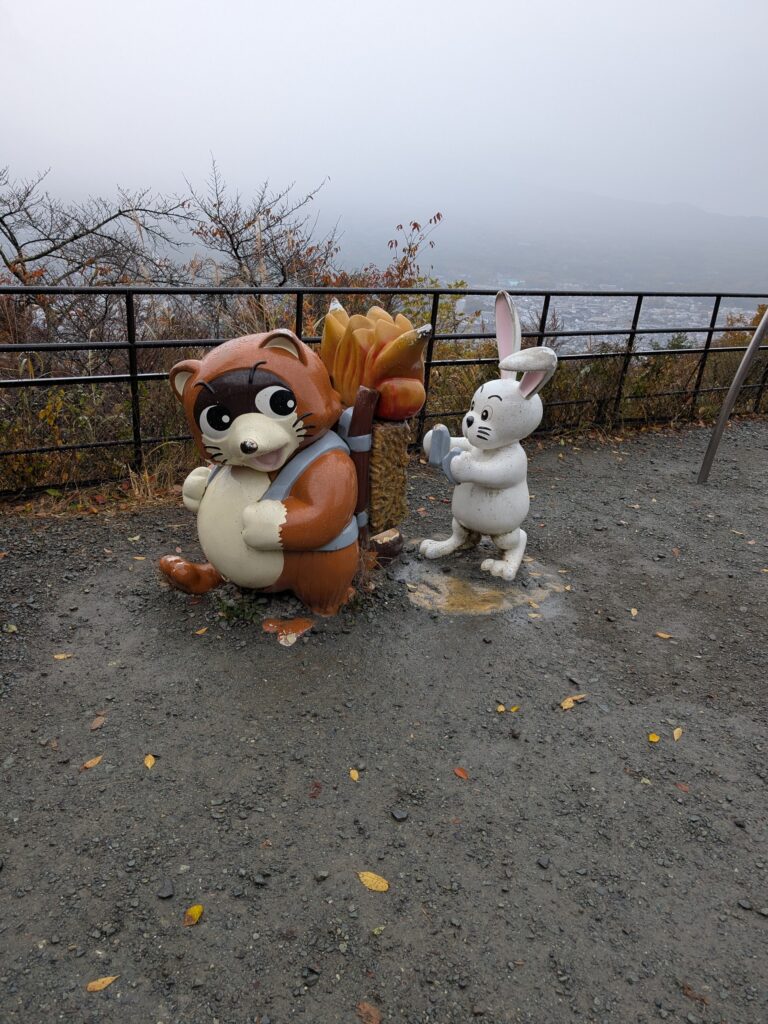 a statue of a bunny lighting logs on a raccoons back on fire